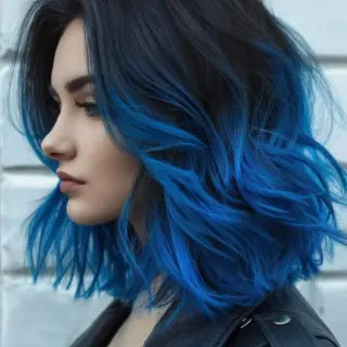 A sleek, straight hairstyle with vivid blue highlights primarily towards the bottom half of the hair. The sharp, straight cut emphasizes the striking color transition, creating a sleek and modern aesthetic with a touch of edge.