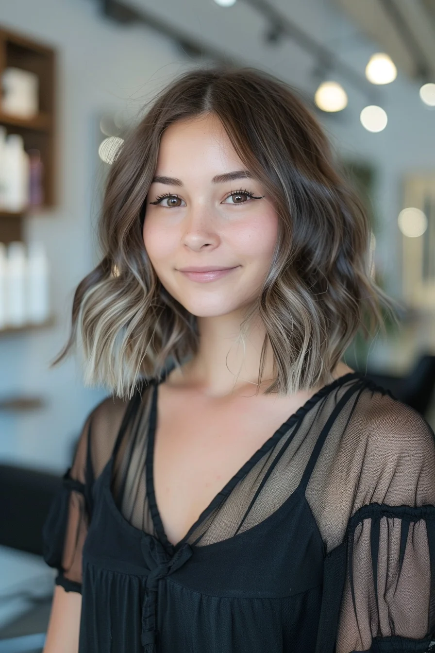 Soft waves bring out the dimension in this shoulder-length cut with its blend of light brown and honey tones. Multiple layers throughout add gorgeous volume and movement. Face-framing pieces begin at the cheekbones, creating a beautiful shape that flows into longer layers.